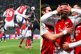 Gabriel celebrating his headed goal from a corner kick, with teammates rushing to congratulate him and the Emirates crowd cheering wildly."